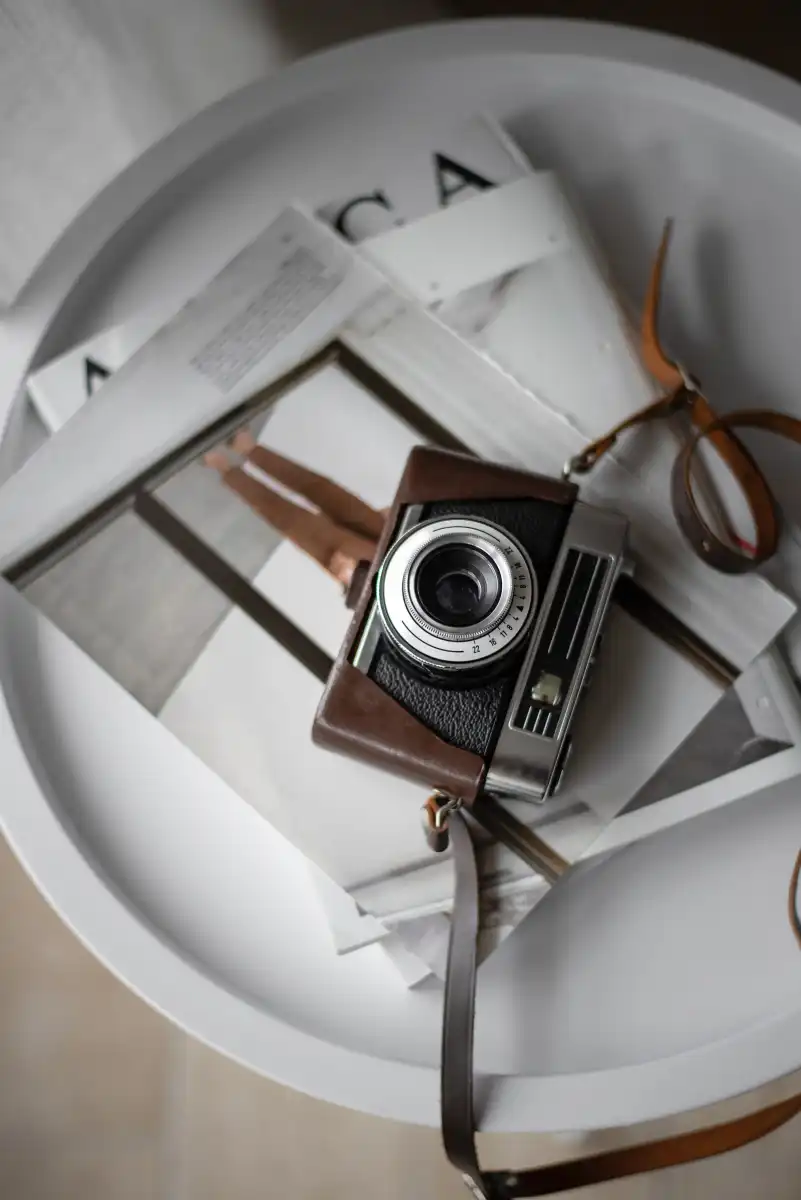 Buying process with camera and magazines on a white tray