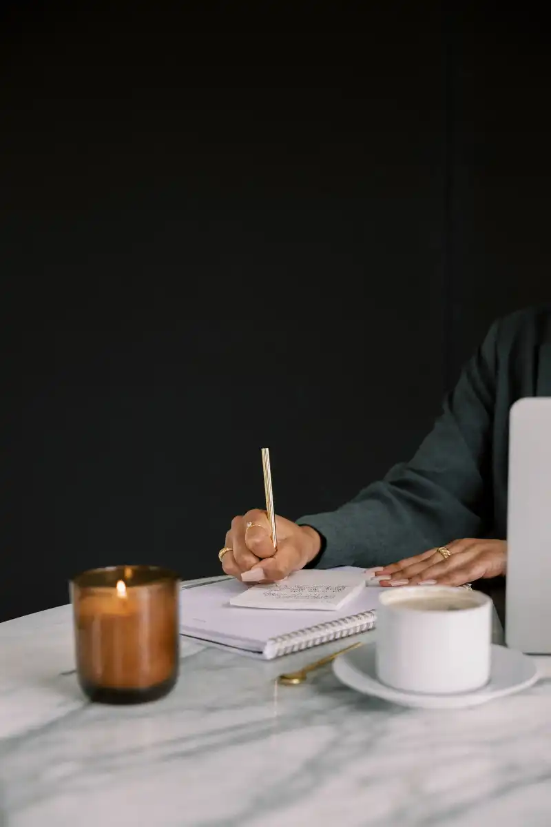 Woman working and writing notes in a notepad