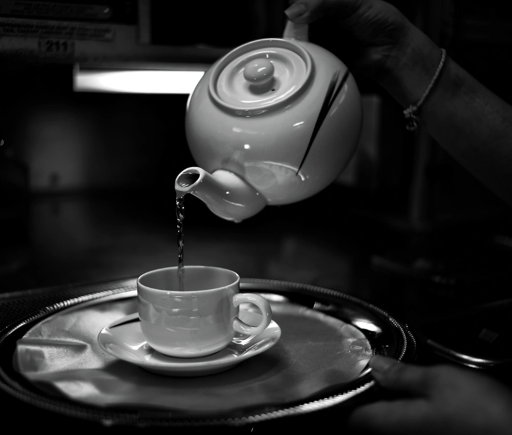 poring tae from Teapot to teacup