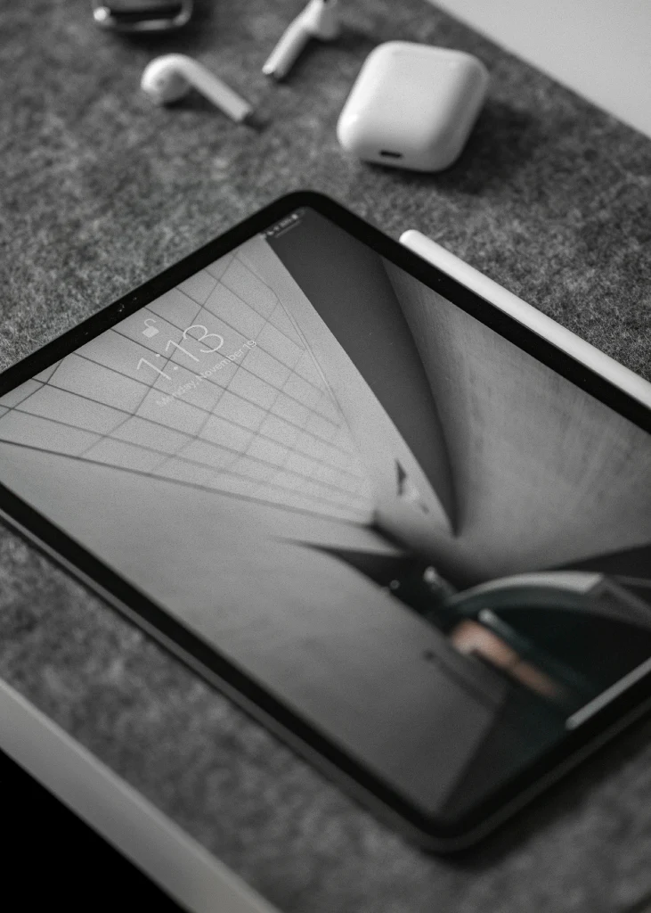 black iPad on grey surface